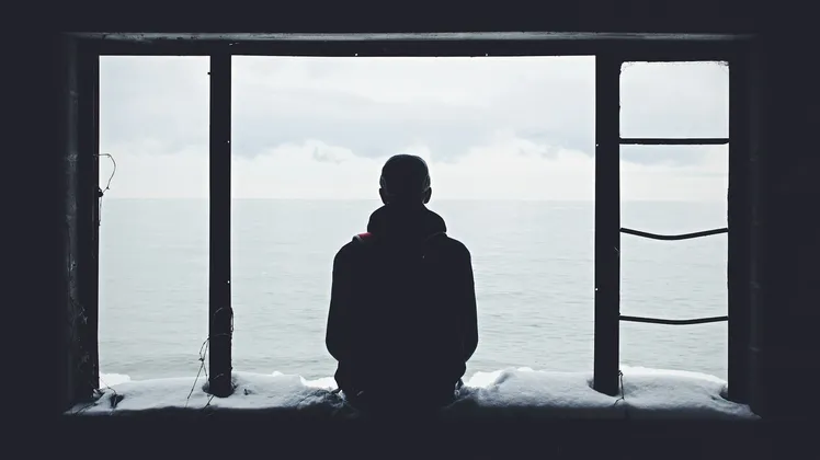 A man sitting alone on the window